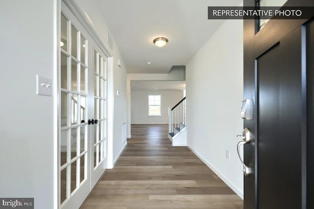 391 Santa Anita Dr Lot 112, Dillsburg, PA 17019 - hallway featuring french doors, stairway, wood finished floors, and baseboards