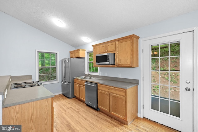 806 Windy Way, Front Royal, VA 22630 - kitchen with appliances with stainless steel finishes, vaulted ceiling, light wood finished floors, a textured ceiling, and a sink