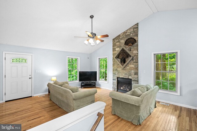 806 Windy Way, Front Royal, VA 22630 - living area with a stone fireplace, a ceiling fan, light wood-type flooring, baseboards, and high vaulted ceiling