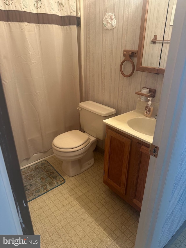 12304 Jamaica Ave Unit 206, Ocean City, MD 21842 - bathroom with vanity, wood walls, toilet, a shower with shower curtain, and tile patterned floors