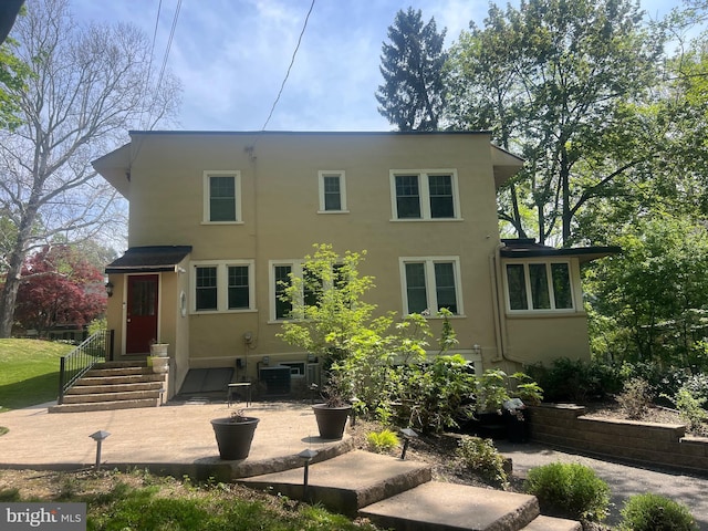 view of front of home featuring a patio and stucco siding