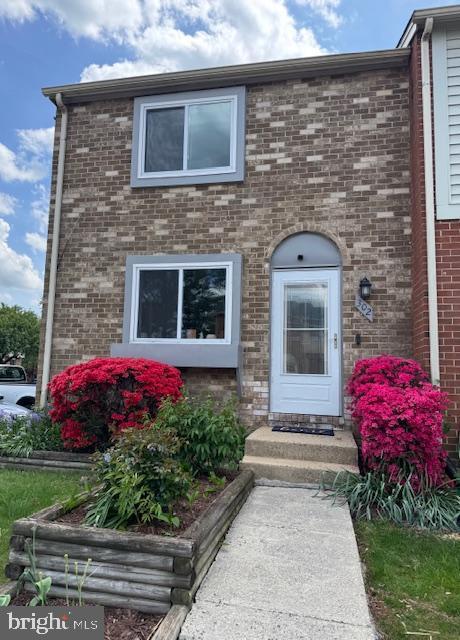 property entrance with brick siding