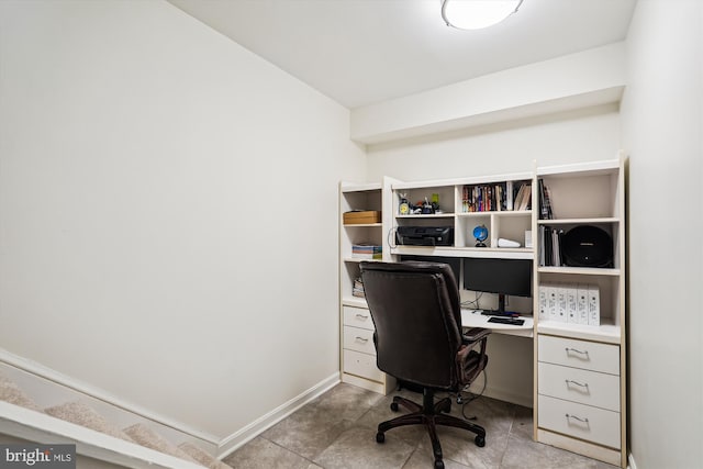 office space with light tile patterned flooring and baseboards