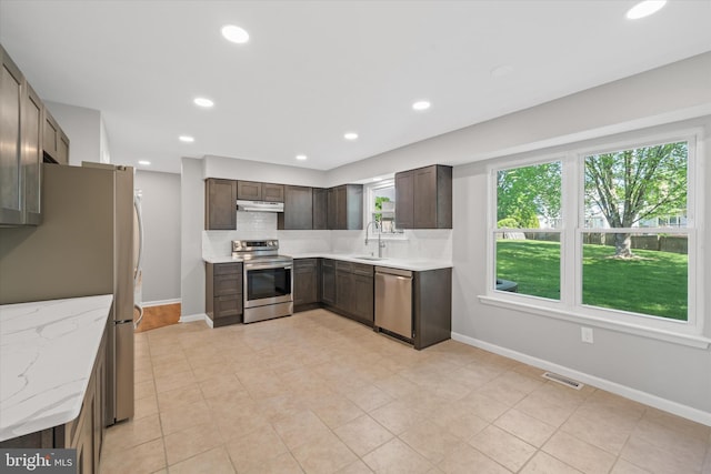 13 Sumac Ct, Newark, DE 19702 - kitchen featuring dark brown cabinetry, a sink, stainless steel appliances, under cabinet range hood, and visible vents