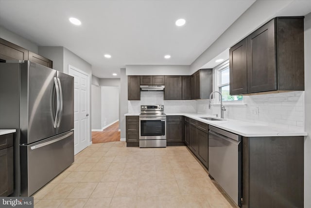 13 Sumac Ct, Newark, DE 19702 - kitchen with dark brown cabinetry, recessed lighting, a sink, appliances with stainless steel finishes, and backsplash