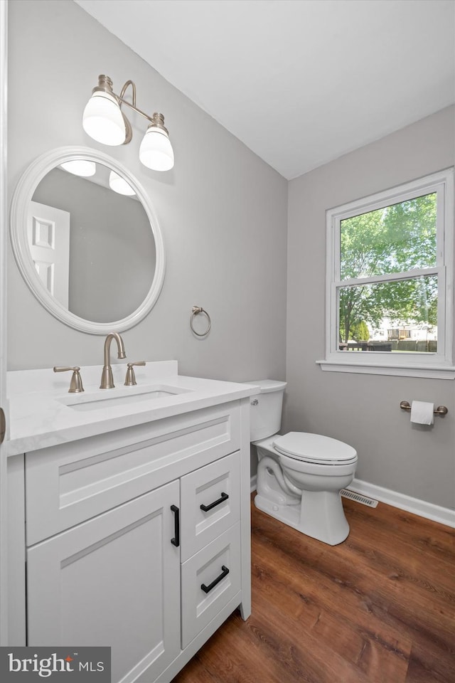 13 Sumac Ct, Newark, DE 19702 - bathroom with vanity, toilet, baseboards, wood finished floors, and visible vents
