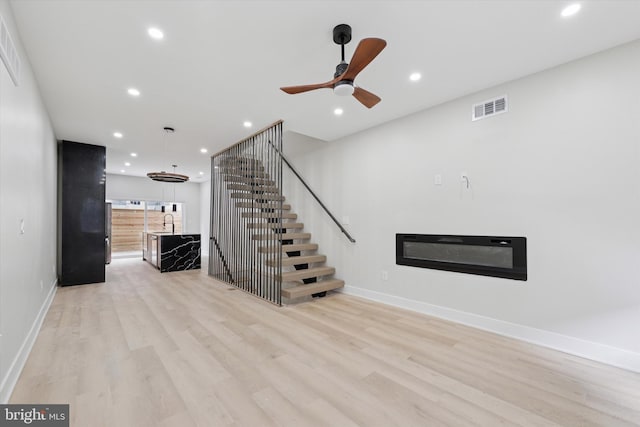 2230 Kimball St, Philadelphia, PA 19146 - unfurnished living room featuring light wood-style floors, recessed lighting, a glass covered fireplace, ceiling fan, and baseboards