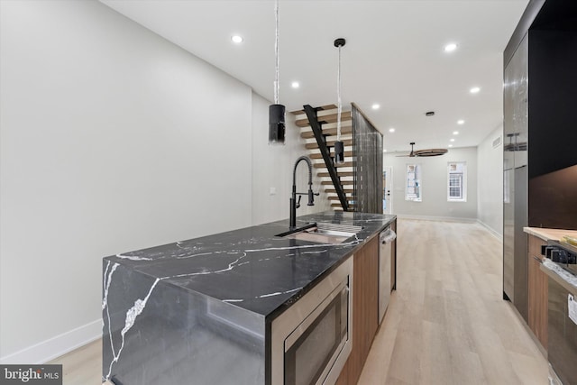 2230 Kimball St, Philadelphia, PA 19146 - kitchen featuring a sink, stainless steel appliances, a large island, light wood-type flooring, and modern cabinets