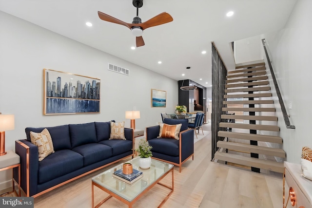 2230 Kimball St, Philadelphia, PA 19146 - living area featuring light wood finished floors, recessed lighting, stairway, and ceiling fan
