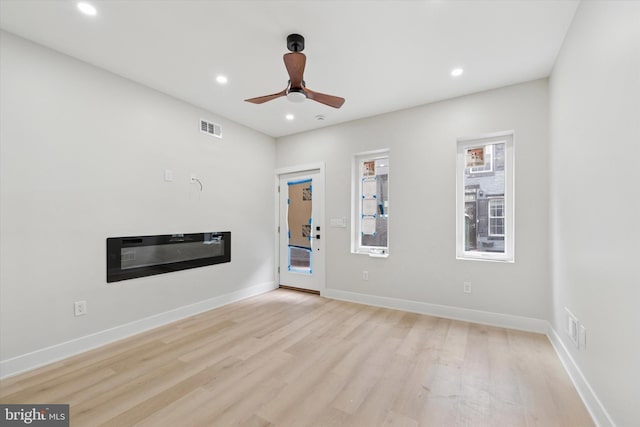 2230 Kimball St, Philadelphia, PA 19146 - unfurnished living room featuring light wood-style floors, recessed lighting, a ceiling fan, baseboards, and a glass covered fireplace