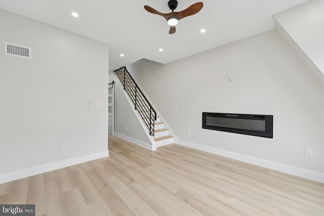 2230 Kimball St, Philadelphia, PA 19146 - unfurnished living room featuring a ceiling fan, a glass covered fireplace, light wood-style floors, stairway, and recessed lighting
