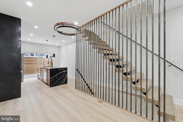 2230 Kimball St, Philadelphia, PA 19146 - stairway with wood finished floors, baseboards, and recessed lighting