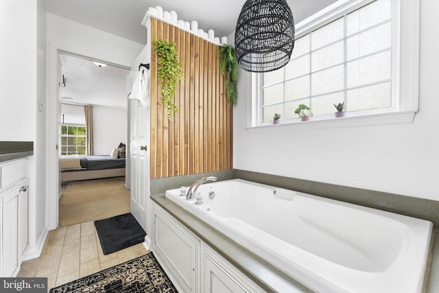 bathroom featuring ensuite bath and a bath