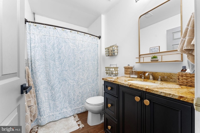 full bath with toilet, curtained shower, wood finished floors, and vanity