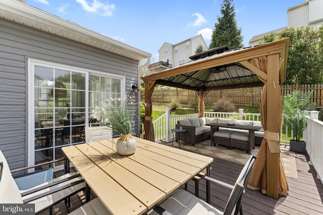 wooden deck featuring a gazebo, fence, an outdoor hangout area, and outdoor dining space