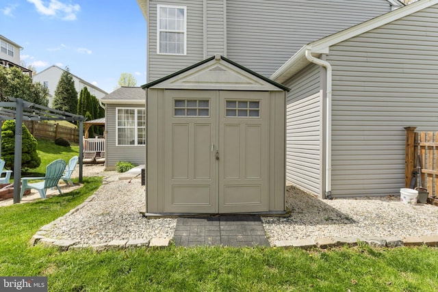 view of shed featuring fence