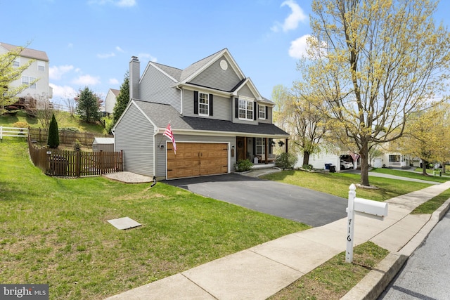 view of front of home featuring fence, a front yard, a chimney, an attached garage, and driveway