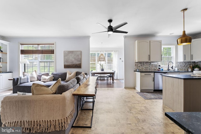 living room featuring crown molding and a ceiling fan