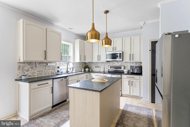 kitchen with a center island, tasteful backsplash, a sink, ornamental molding, and stainless steel appliances