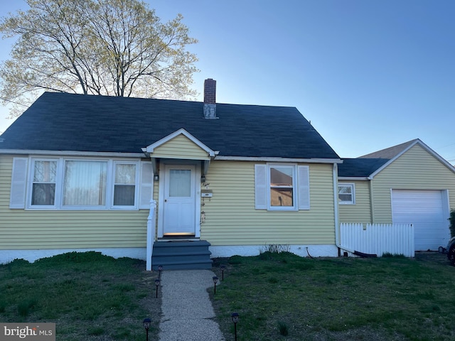 8 Sullivan Ave, Bellmawr, NJ 08031 - view of front of property featuring a chimney, a front yard, and a garage