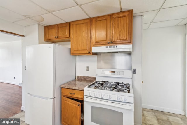 8 Sullivan Ave, Bellmawr, NJ 08031 - kitchen featuring white appliances, under cabinet range hood, a drop ceiling, brown cabinets, and baseboards