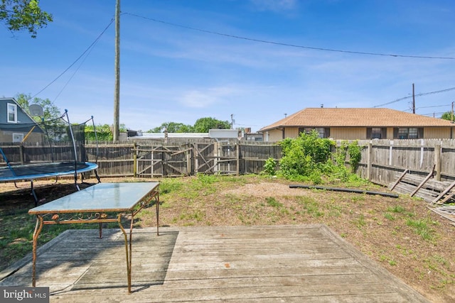8 Sullivan Ave, Bellmawr, NJ 08031 - wooden terrace with a trampoline and a fenced backyard