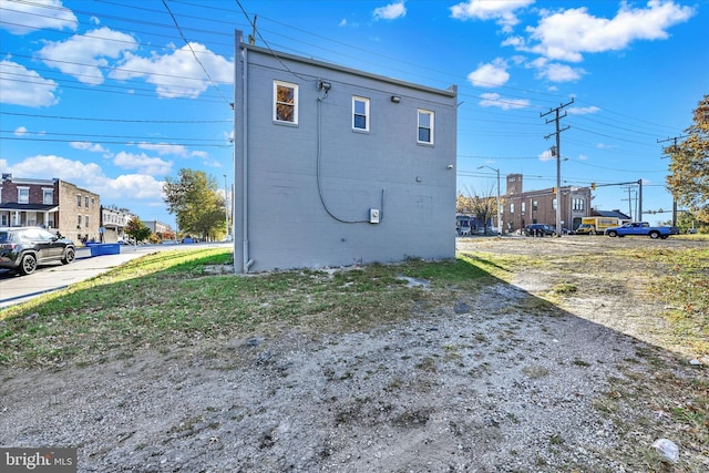 view of side of home with a residential view and uncovered parking