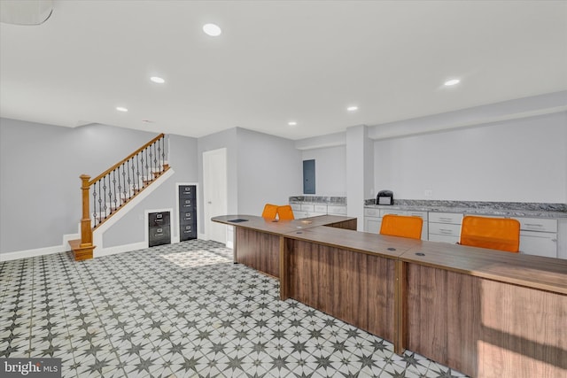 kitchen with recessed lighting, baseboards, light countertops, and light floors