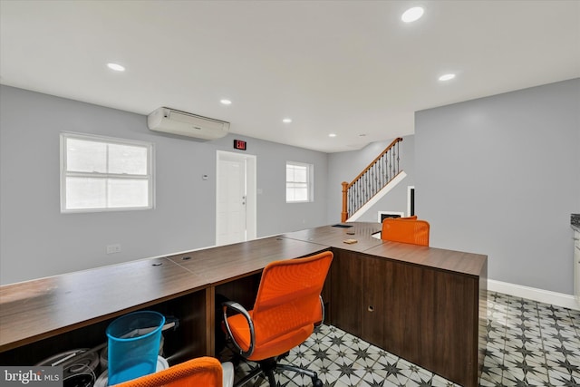 office area featuring recessed lighting, baseboards, a wall mounted AC, and light floors
