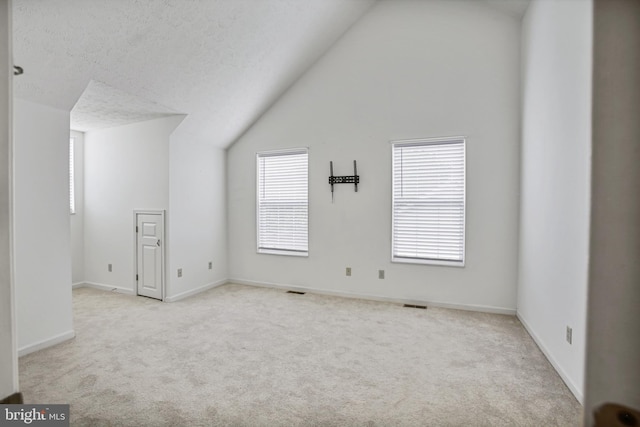 bonus room featuring carpet floors, visible vents, baseboards, and lofted ceiling