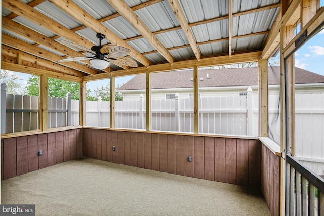 unfurnished sunroom with a ceiling fan