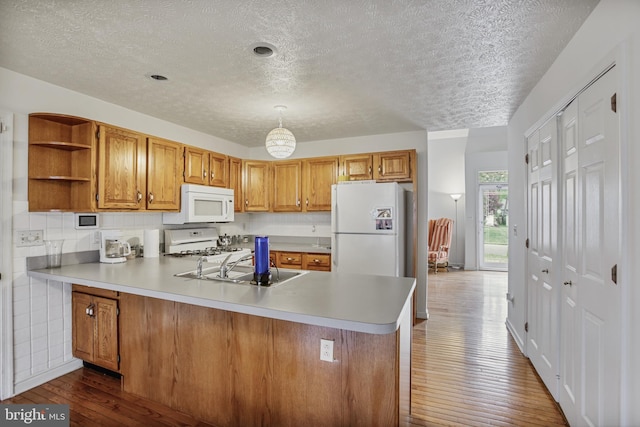 kitchen with open shelves, a textured ceiling, dark wood finished floors, and white appliances