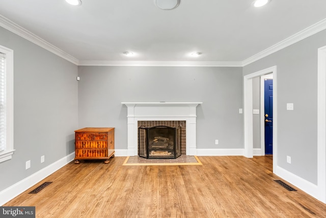 unfurnished living room featuring crown molding, visible vents, and light wood-style flooring
