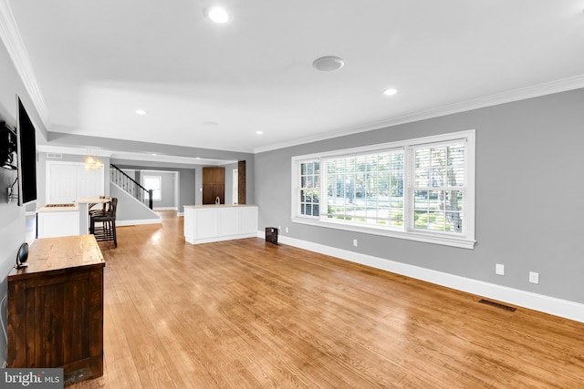 unfurnished living room with visible vents, ornamental molding, stairs, baseboards, and recessed lighting