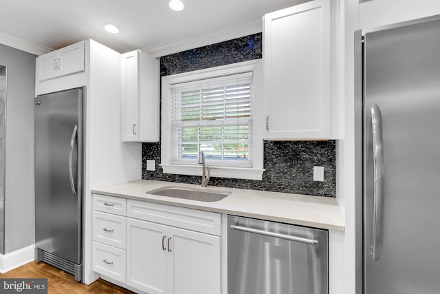 kitchen with recessed lighting, a sink, white cabinetry, and stainless steel appliances