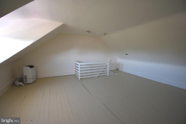 bonus room with baseboards, wood-type flooring, and lofted ceiling