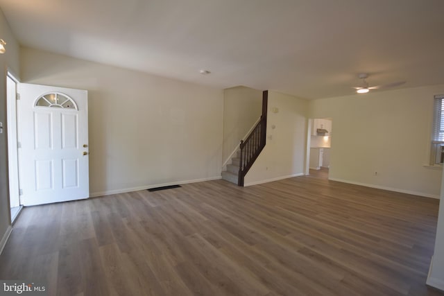 interior space featuring baseboards, ceiling fan, wood finished floors, and stairway