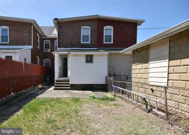 back of house featuring a fenced backyard