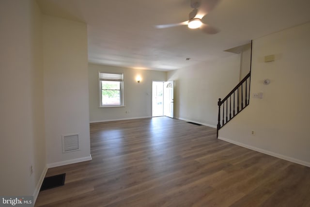 interior space with visible vents, stairs, ceiling fan, and wood finished floors