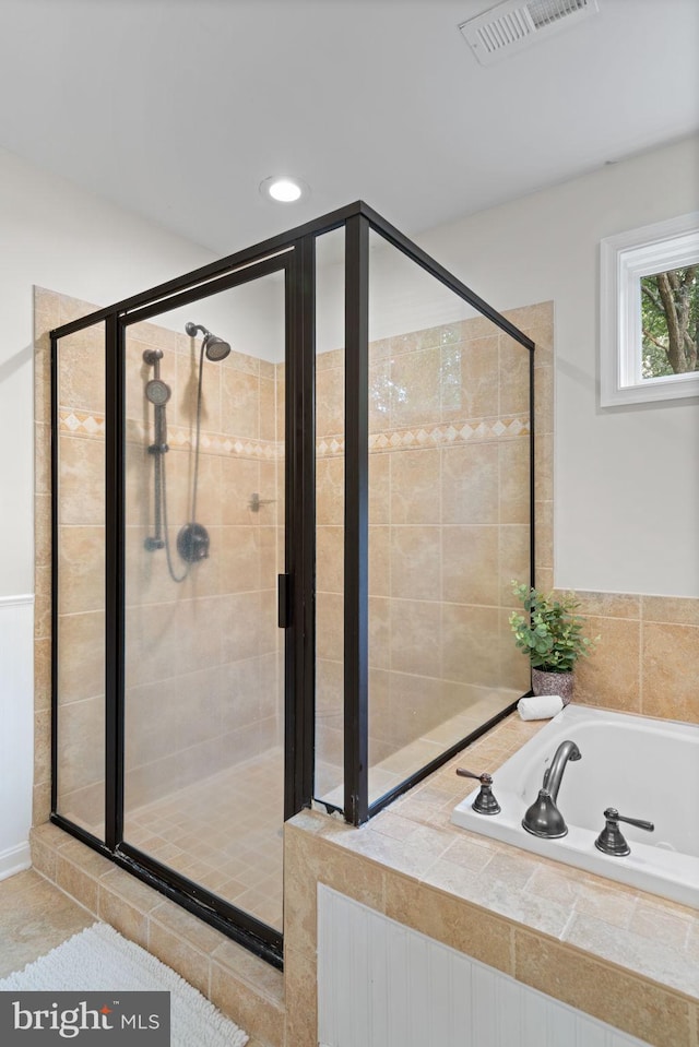 full bath featuring a garden tub, visible vents, and a shower stall