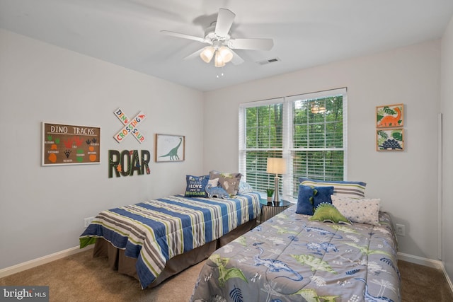 carpeted bedroom with baseboards, ceiling fan, and visible vents