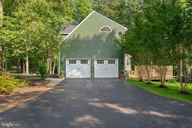 view of home's exterior with a garage and driveway