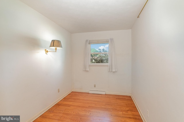 unfurnished room with light wood-type flooring and baseboards