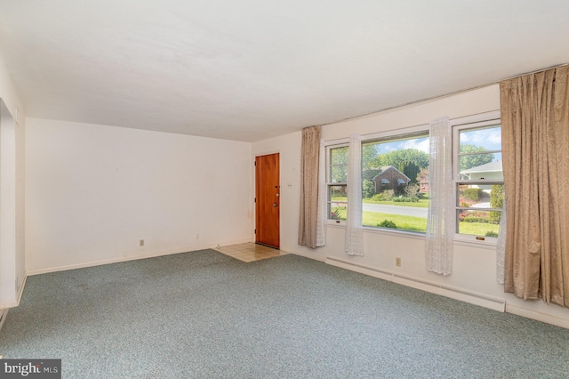 carpeted spare room featuring baseboards and baseboard heating