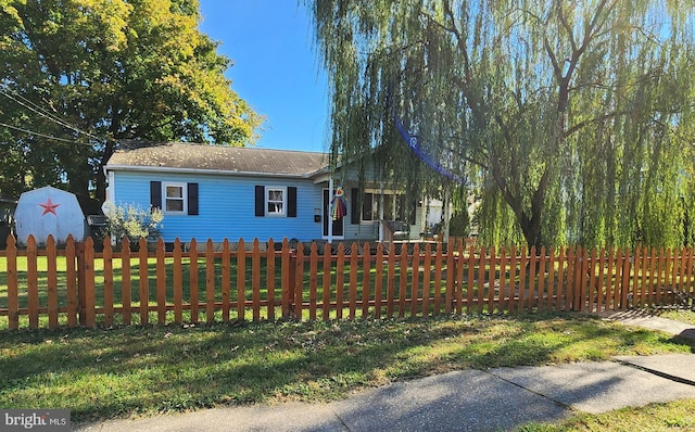ranch-style house with a fenced front yard