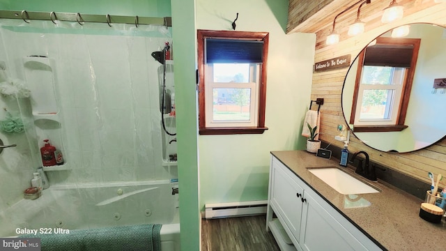 bathroom with plenty of natural light, wood walls, a baseboard heating unit, and vanity