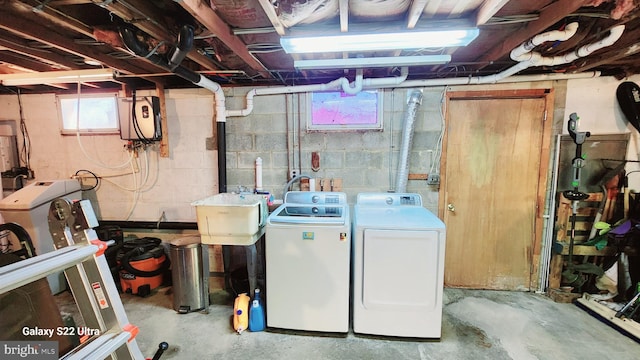 basement featuring a sink and separate washer and dryer