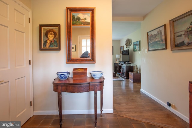 hallway featuring baseboards