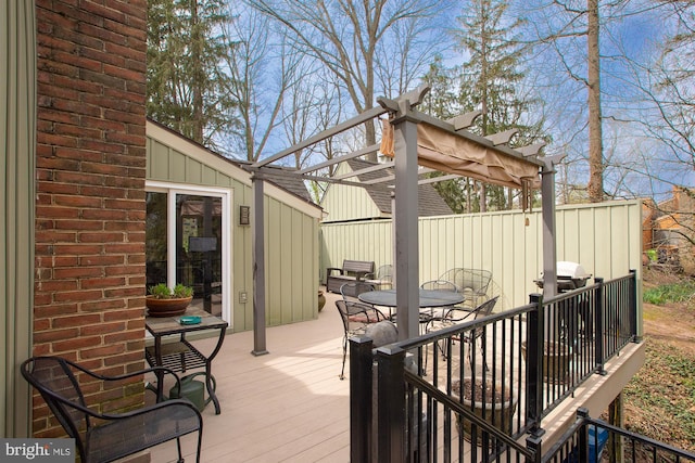 wooden deck featuring outdoor dining area and a pergola