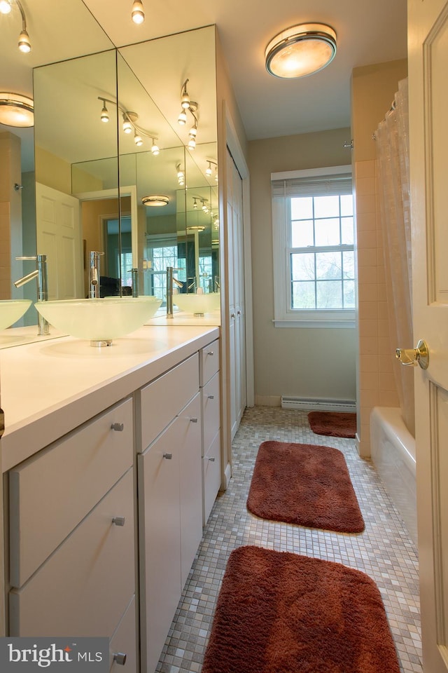 bathroom with baseboards, tile patterned flooring, and vanity